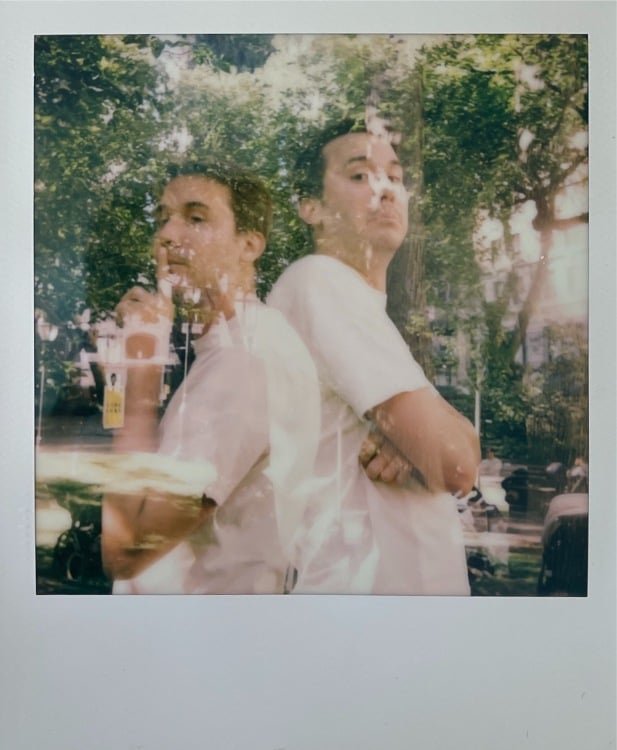 double exposure polaroid showing a man posing with himself